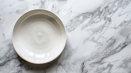 Top view of white ceramic dish on marble table texture