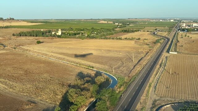 Shadow of a jet airplane flying very low over the ground approaching to the airport to land, as seen by the pilot from the cockpit early in the morning. 4K 60FPS