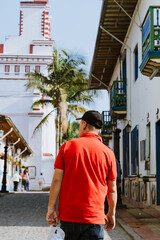 Traveling man in black cap and red shirt. Traveling in villages in Colombia.