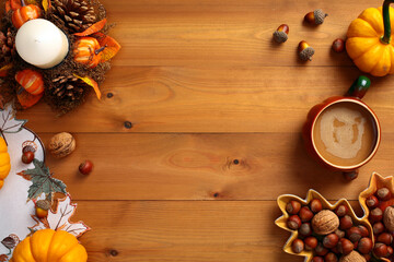 Pumpkins and autumn decor on dark wood background. Flat lay, top view, copy space.