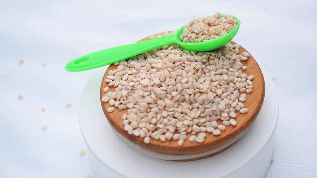 The Stone Grouted Organic Urad Dal Without Skin Vigna mungo, Black Gram, mash kalai, uzhunnu parippu, ulundu paruppu, minapa pappu, Uddu or black, plastic spoon 