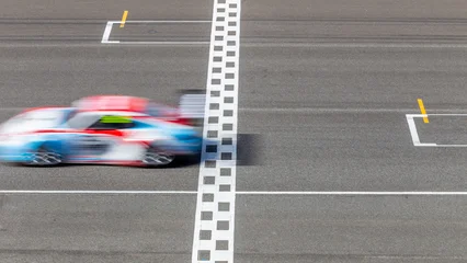 Fotobehang Formule 1 Motion blur race car racing on speed track, Car race on the international circuit race track crossing start and finish line, Race car crossing start and finish line, Target business achieve.  © Kalyakan