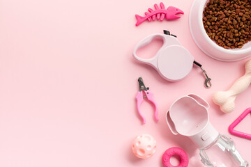 Collection of pet supplies on a pastel pink background. Flat lay, top view.