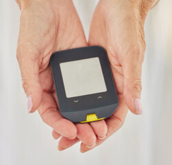 Glucometer, test and hands with screen in home for blood, stats and mockup space with sugar level for wellness. Machine, ux and senior person with diabetes to monitor glucose in house for healthcare