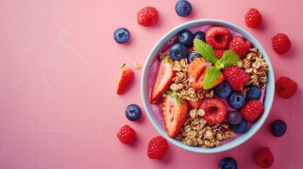 Summer acai bowl with mixed fruit and granola on pink background Breakfast bowl with fruit and cereal close up top view text space