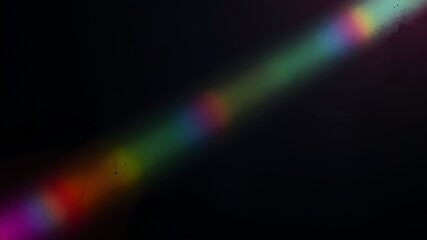 Rainbow ray light on black background. Crystal flare abstract effect.	