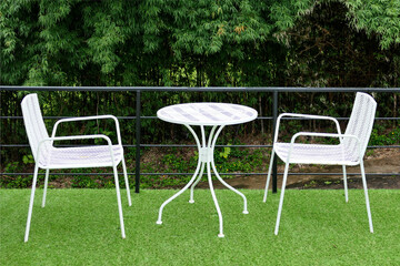 white chairs and table in lawn of garden