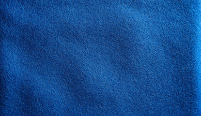 Close-up of a textured blue fabric with diagonal folds.