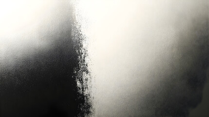 Abstract gradient of black and white tones with textured surface.