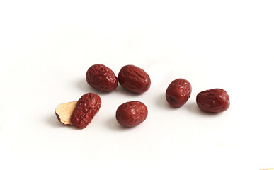 Dried red dates isolated on a white background. They are a traditional herb used in Chinese medicine. Full depth of field.