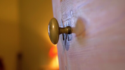 Slow orbiting shot of a brass rusted doorknob on a bedroom door - Powered by Adobe