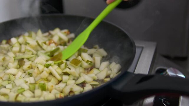 Cooking apple in a frying pan. Fried apples with honey sugar, fall side dish. Glazed cinnamon Apple Fritter Skillet. Caramel. Homemade autumn sweet dessert. Ingredients for crumble, tart, crisp or pie