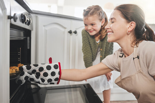 Mom, kid and cookies at oven for learning, bonding and baking in home with smile, love and sweets. Teaching, mother and daughter together in kitchen with biscuit dough, fun and girl child development
