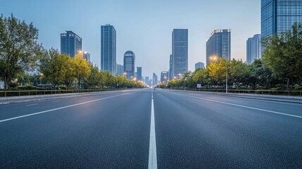 Empty asphalt road in the city with skyscrapers and trees on both sides.