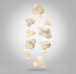 Delicious khinkali (Georgian dumplings) falling on grey gradient background