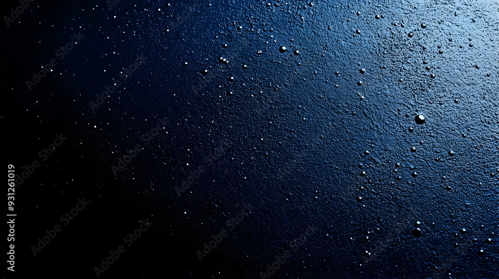 Poster Close-up of water droplets on a dark textured surface.