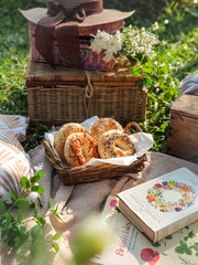 Picnic in garden. Reading books. Breakfast bagels in park. Summer vibes.
