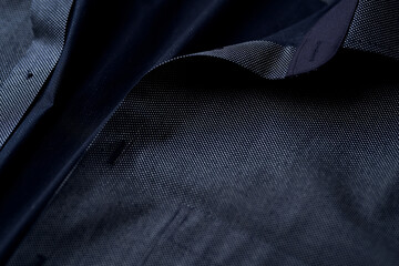 Close up of dark Men's shirt. Soft focus. Copy space.	