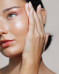 Latina Beauty with Glowing Skin Posing with Hand on Cheek Against Pink