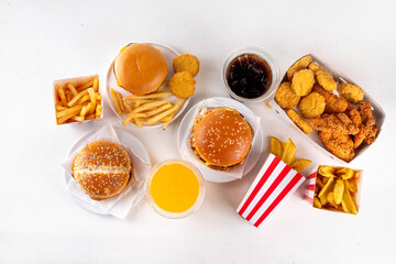 Fast food delivery menu background with various burgers, cheeseburger, nuggets, french fries, fizzy soda drinks. Junk unhealthy fast food, Ultra processed food with low nutrition, high calories value
