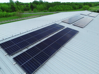 Solar panel array on industrial rooftop in countryside