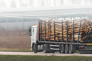 Logging truck with timber load on country road