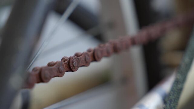 Rusted bicycle chains with a reddish-brown patina, showing years of wear