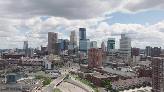 Aerial pull backshot of Minneapolis skyline with Highway 394 in USA. Drone view.