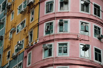 Colorful round building in Hong Kong showcases vibrant architectural design and bustling urban life