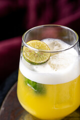 Satsuma cocktail in glass on dark background