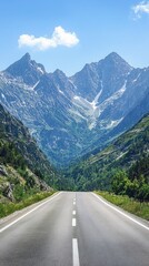 A scenic road winds through majestic mountains under a clear blue sky, perfect for adventure and exploration.