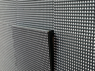 A close-up view of a single square LED module that has not taken its place on the surface of a...