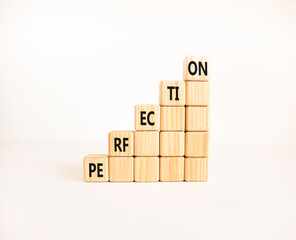 Perfection symbol. Concept word Perfection on beautiful wooden blocks. Beautiful white background. Business perfection concept. Copy space.