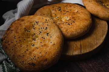 Flatbreads on a dark background. Freshly baked homemade bread