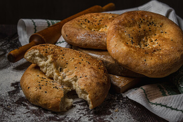 Flatbreads on a dark background. Freshly baked homemade bread