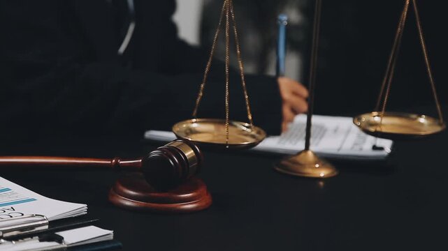 Business and lawyers discussing contract papers with brass scale on desk in office. Law, legal services, advice, justice and law concept picture with film grain effect