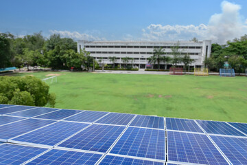 Solar panels on the roof of a remote school provide a sustainable energy solution, reducing...