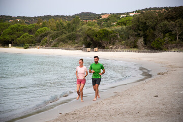 young couple running on the beach