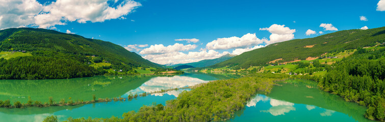 Obraz premium Panoramic view from above on beautiful mountain lake Lalmsvatnet on a sunny summer day. Lalm, Norway. Horizontal banner