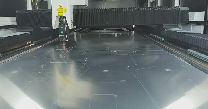 The laser cutter will cut the part. The process of cutting a metal part with a laser cutter. Laser cutter Plasma cutter work at the factory.