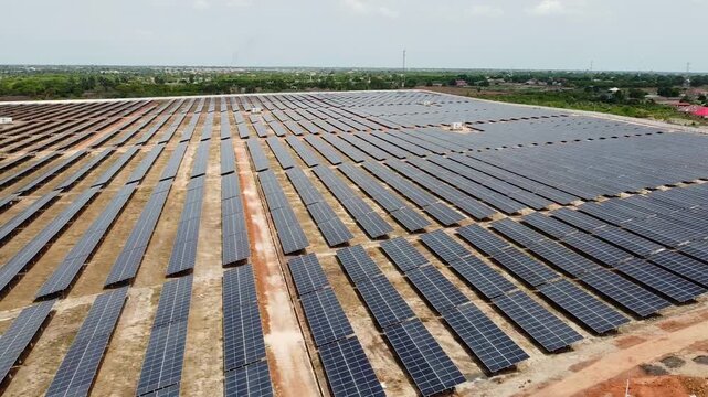 Aerial sliding overview of solar PV array power plant in Gambia, West Africa - NAWEC TBEA Jambur