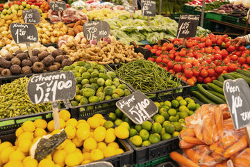 Tomatoes, cucumbers, onions, green beans, lemons, ginger and other vegetables offerde at a market stall in Rotterdam.