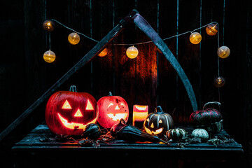 halloween - Jack O' Lanterns - Candles And String Lights On Wooden Table
