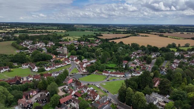 Pull back drone aerial reverse reveal clouds Finchingfield Village in Essex UK drone aerial view