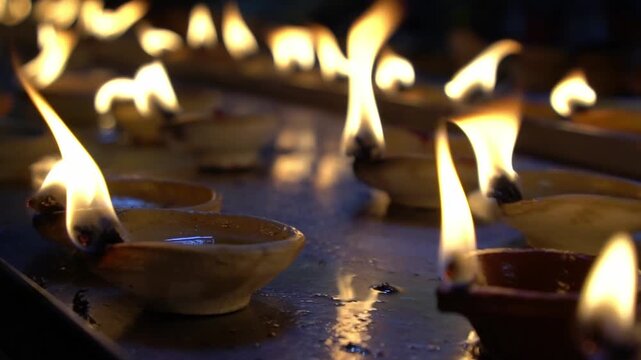 Lit candles inside a hindu temple.