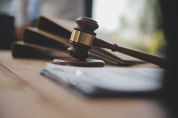 Judge gavel with Justice lawyers having team meeting at law firm background. Concepts of Law and...