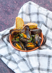 mussel soup boiled with parsley garlic in a steel pot with light background
