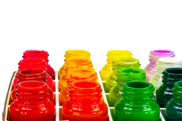 A vibrant display of various colored ink bottles arranged in a grid pattern, showcasing a spectrum of bright and vivid hues. The image highlights the rich and diverse palette of colors for art.