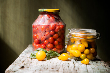red and yellow cherry tomatoes in a jar for winter