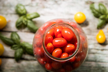 red and yellow cherry tomatoes in a jar for winter